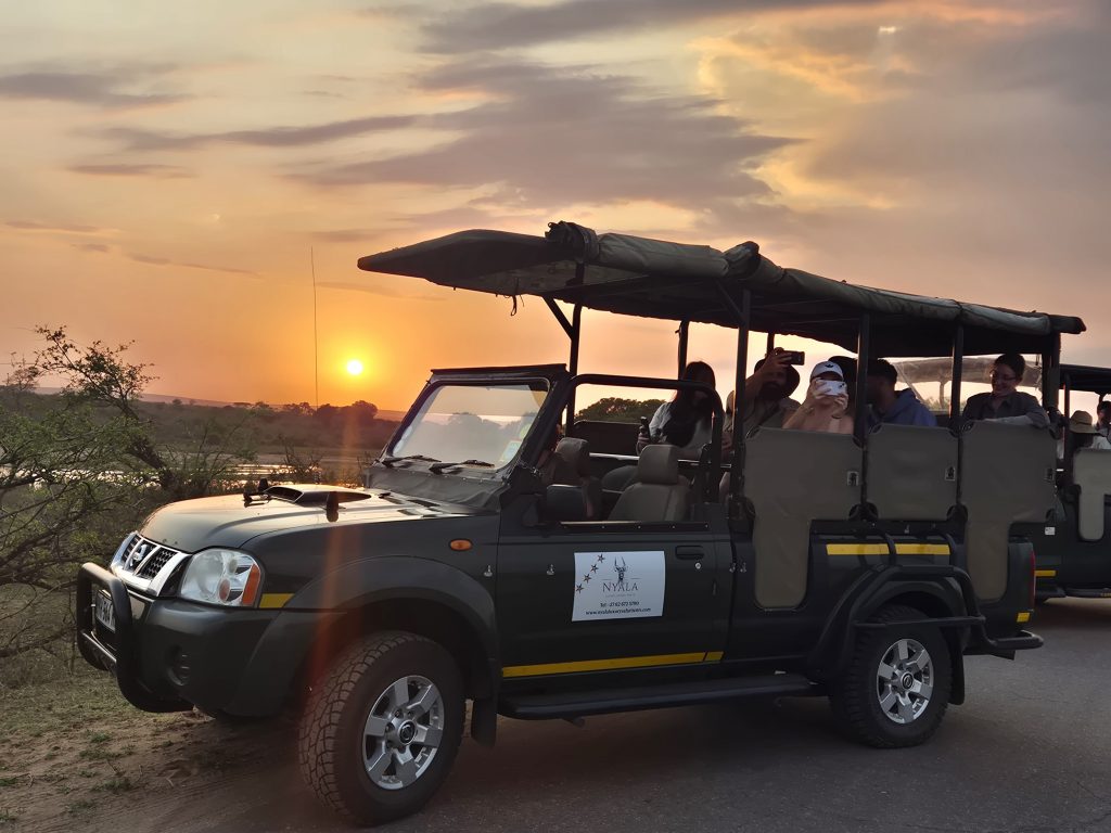 Sunrise behind open safari vehicle during early morning Kruger Safari & Activities